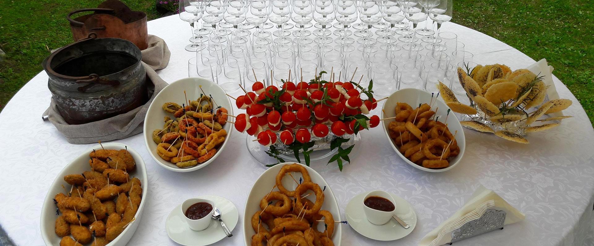 Elegant table with colorful snacks and glasses ready for an outdoor party.