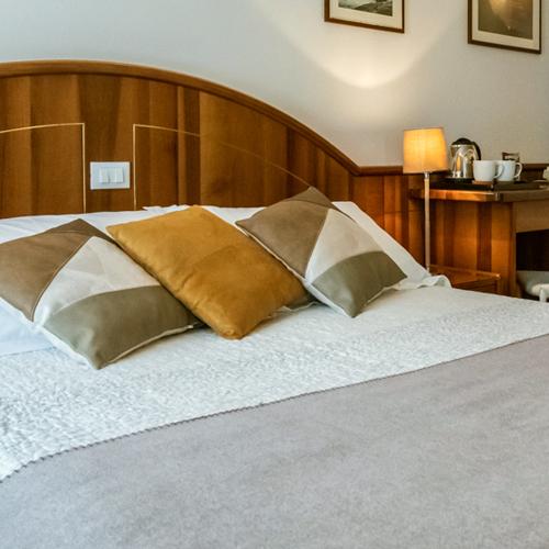 Cozy room with soft bed, colorful pillows, and warm lighting.